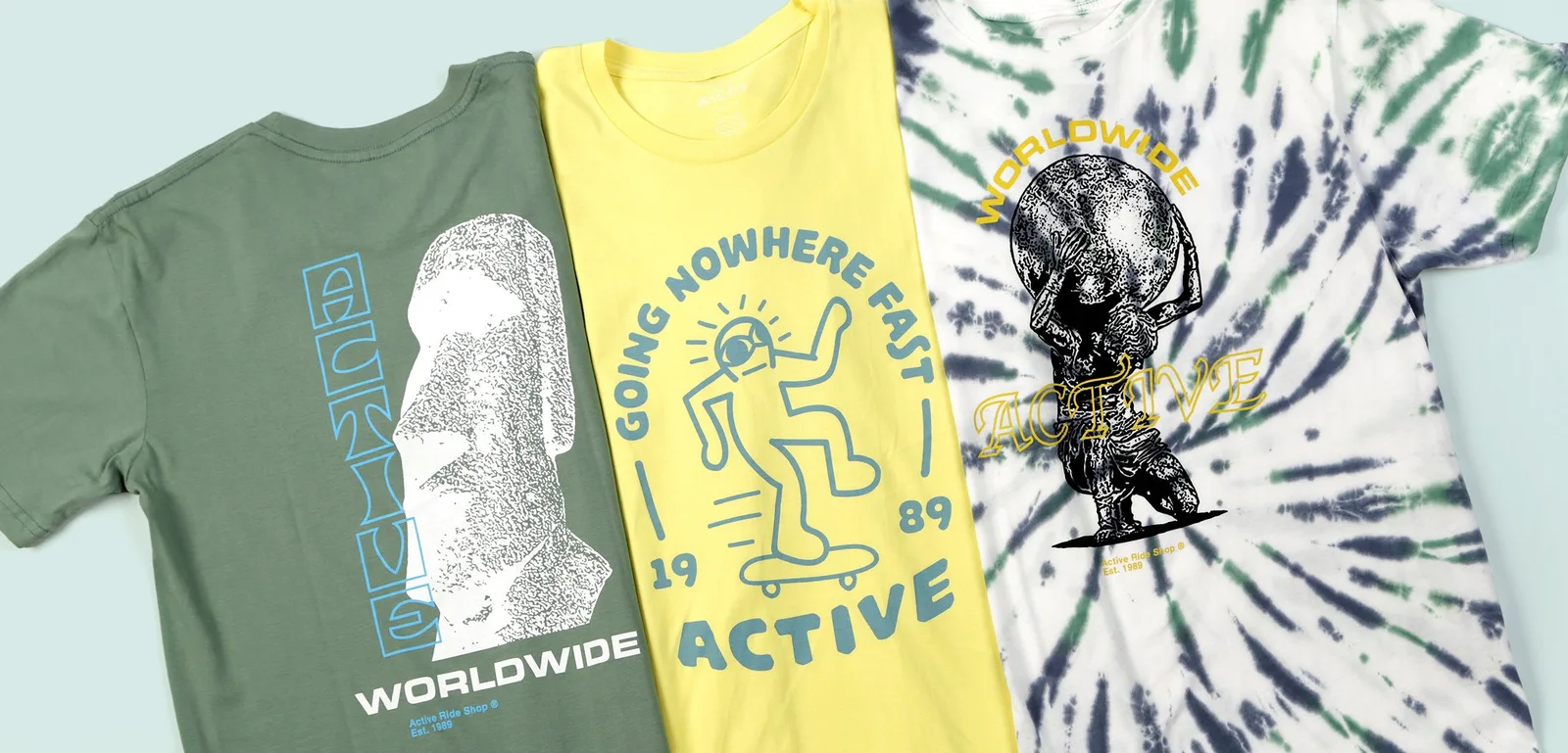 Three Active Ride Shop graphic tees in green, yellow and tie-dye laid flat