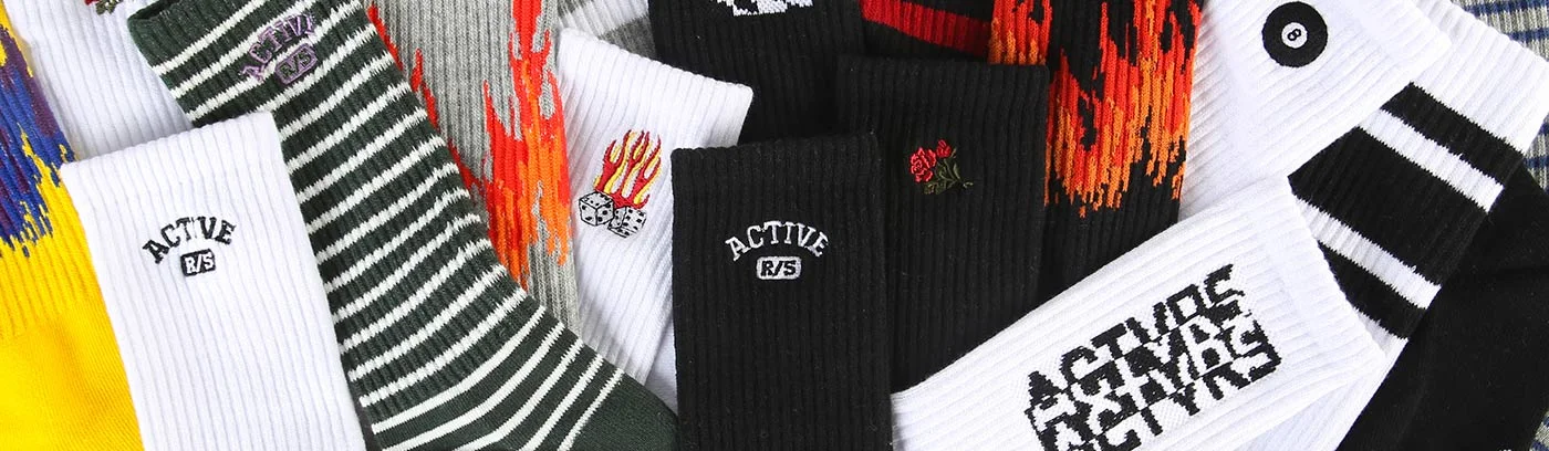 Spread of Active-brand crew socks in stripes, flames and logo designs