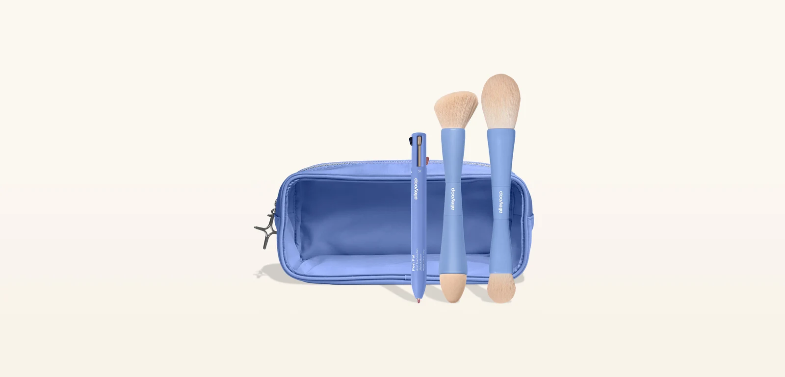 Alleyoop makeup brushes and a multi-pen beside a blue zip pouch on a cream backdrop