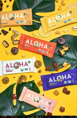 ALOHA plant-based protein bar lineup on yellow backdrop