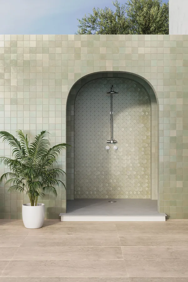 Outdoor shower set in an arched niche lined with green Bedrosians square tile