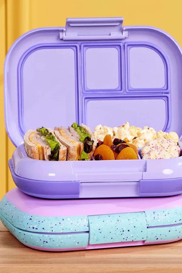 Purple Bentgo kids lunch box packed with sandwiches and snacks
