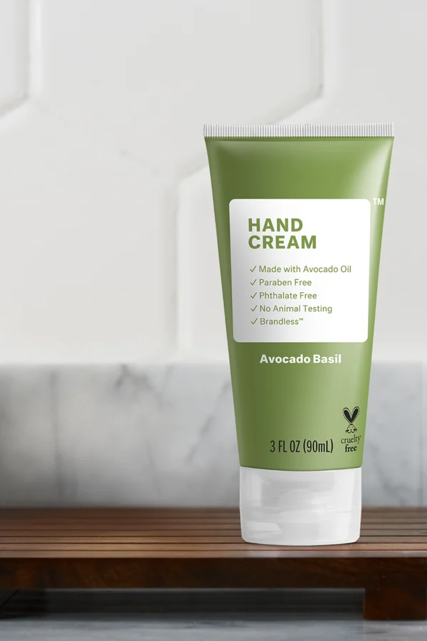 Brandless Avocado Basil hand cream on a wooden bath tray