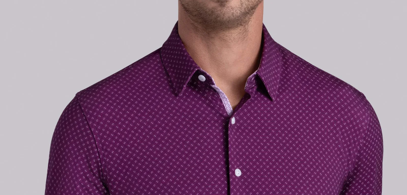 Close-up of a man wearing a purple patterned Buttercloth button-up shirt