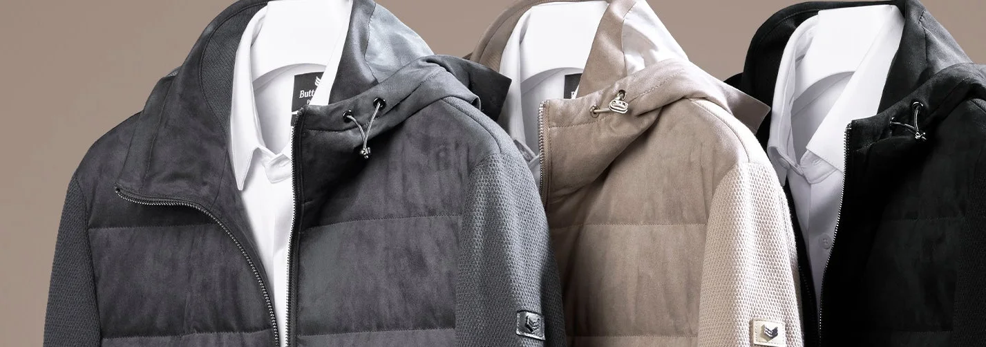 Three Buttercloth hooded jackets in grey, taupe and black over white shirts