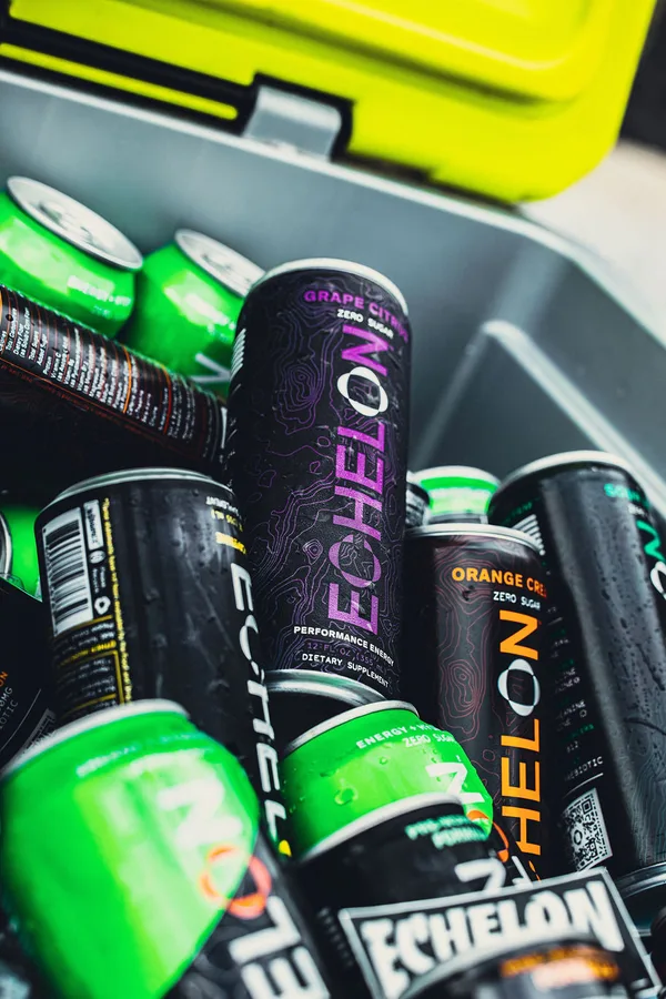 Cooler full of iced Echelon energy drink cans in Grape Citrus, Orange Cream and Energy + Hydration flavors