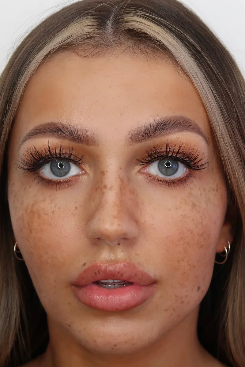 Model with freckles wearing Lilly Lashes Goddess strip lashes