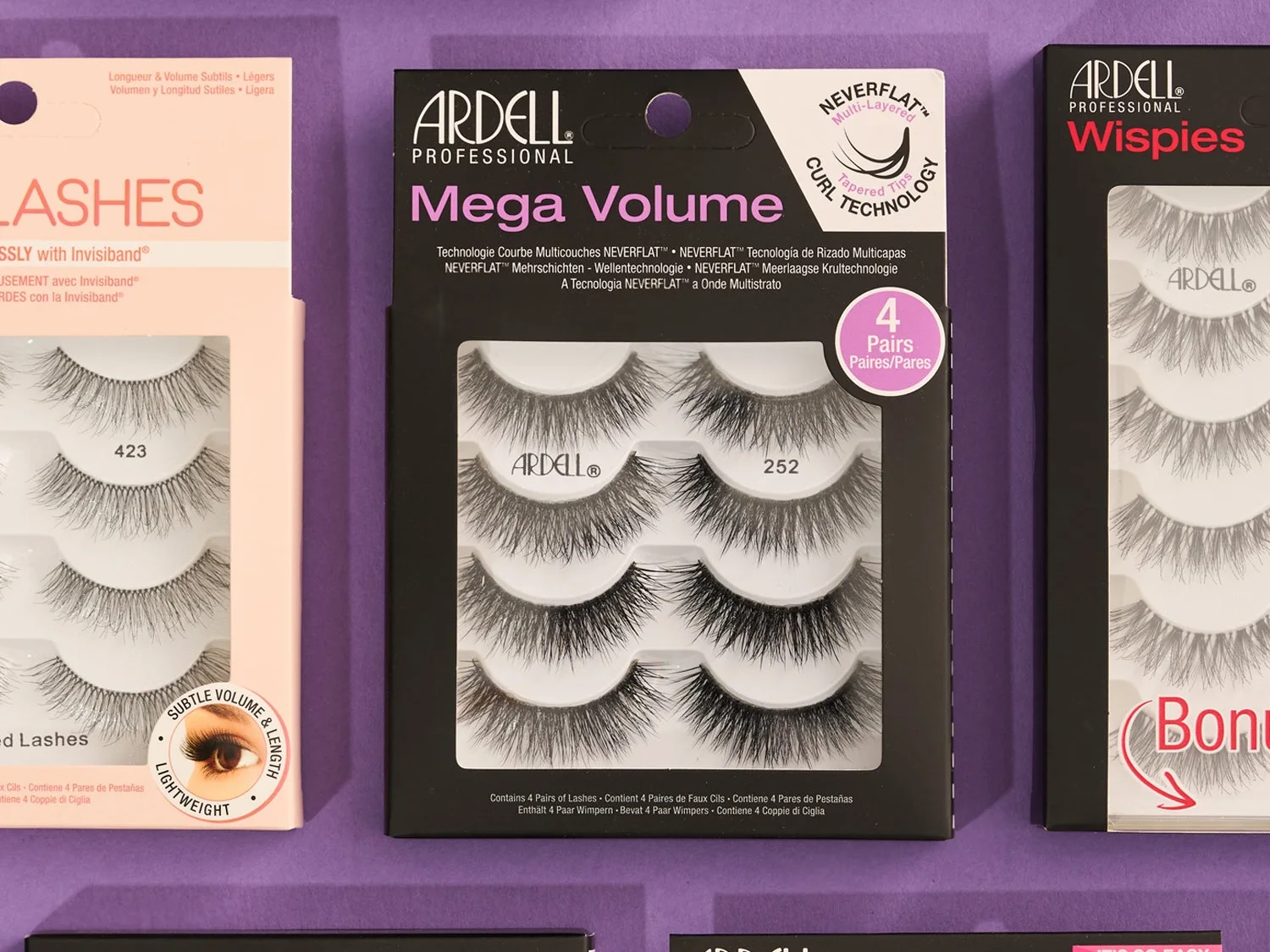 Ardell Mega Volume four-pair lash pack between Ardell Wispies and Naked lash packs on purple