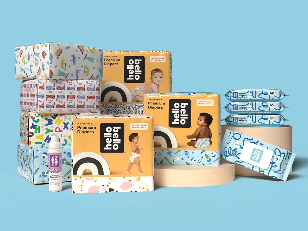 Hello Bello diaper jumbo packs, wipes and Shampoo & Wash on a blue backdrop