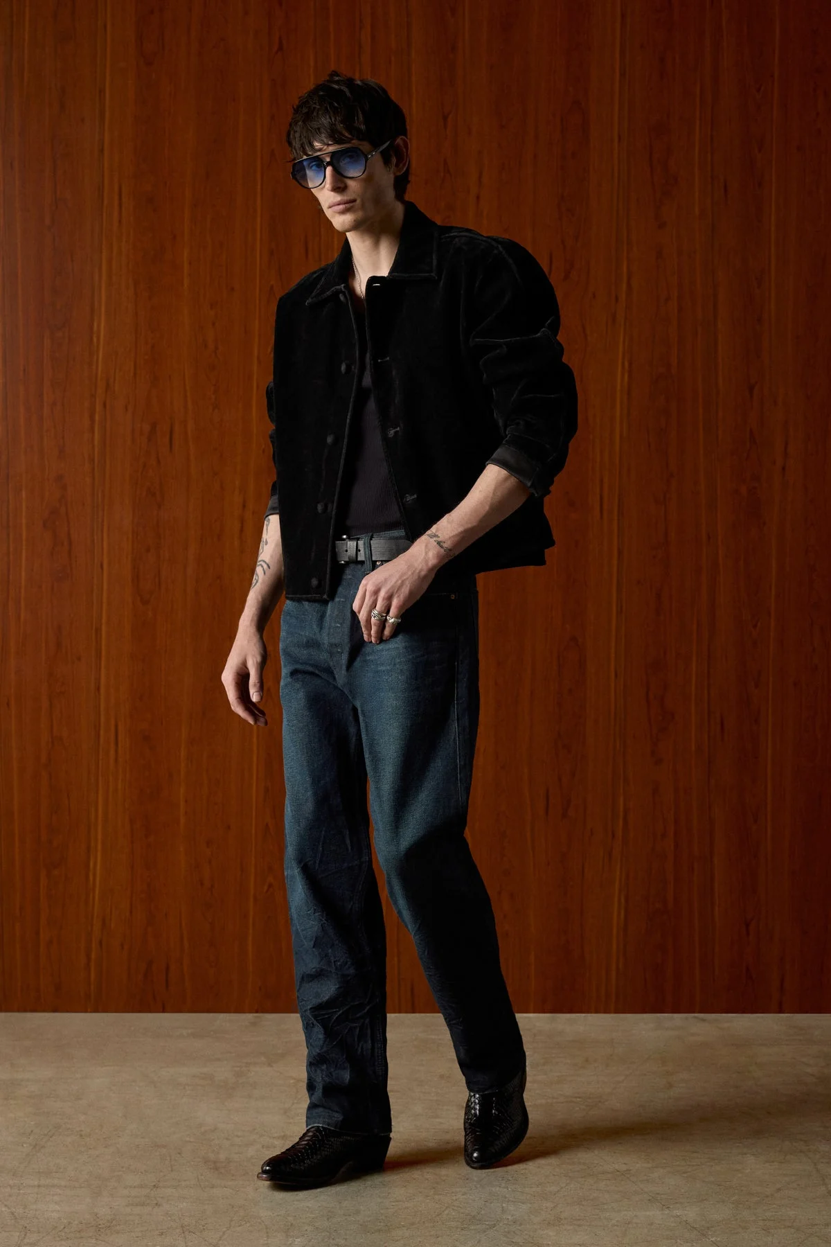 Model in a black trucker jacket and straight-leg Hudson jeans