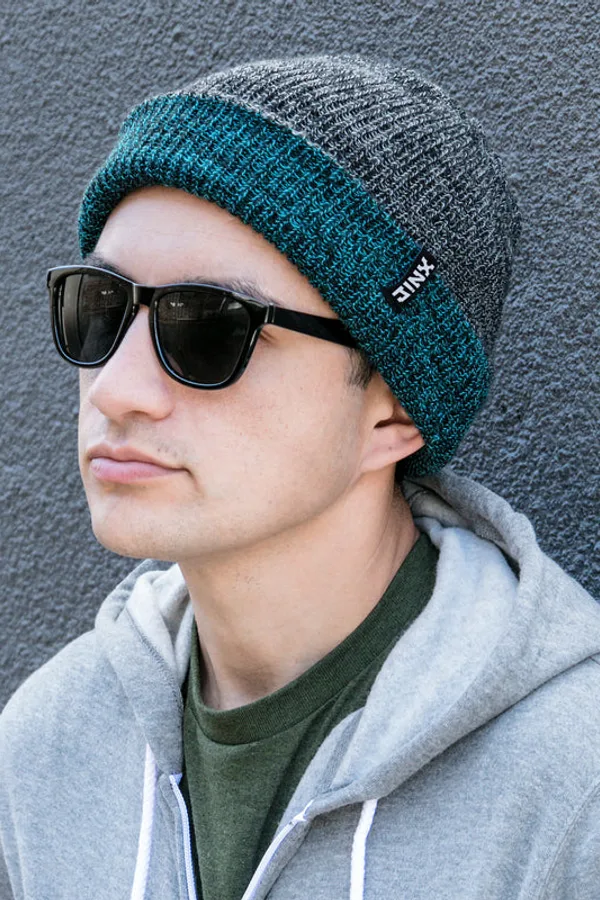 Man in sunglasses wearing a teal and grey J!NX beanie and hoodie
