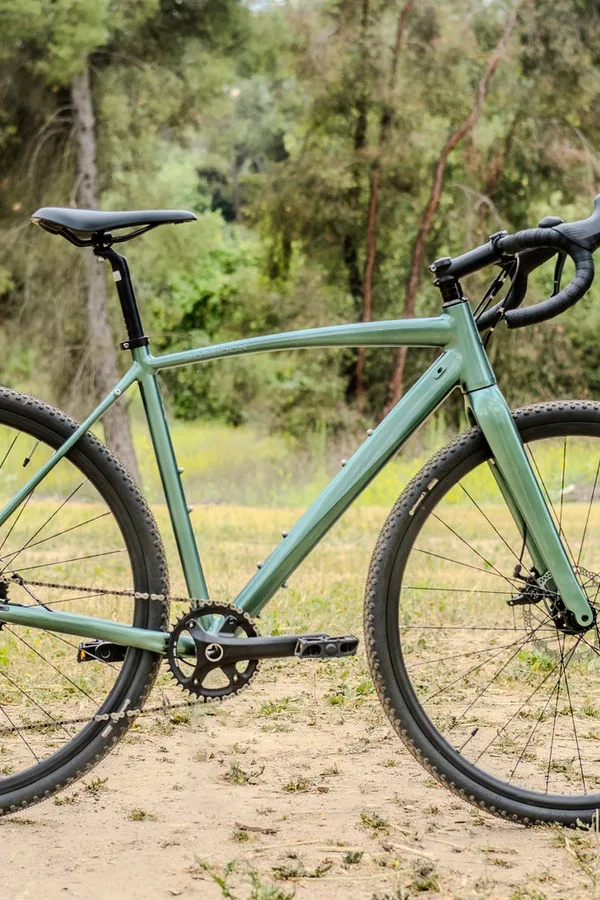 A Poseidon gravel bike on a dirt trail