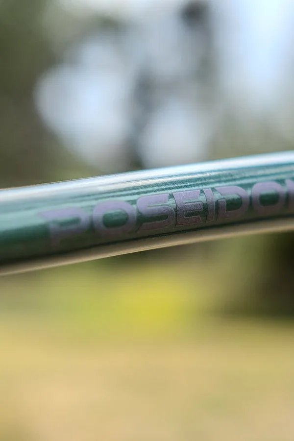 Close-up of the Poseidon wordmark on a bike frame