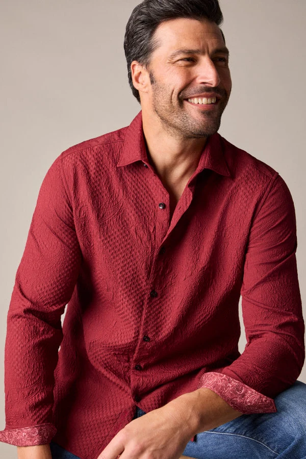 Smiling model in a red Robert Graham button-down shirt with patterned contrast cuffs