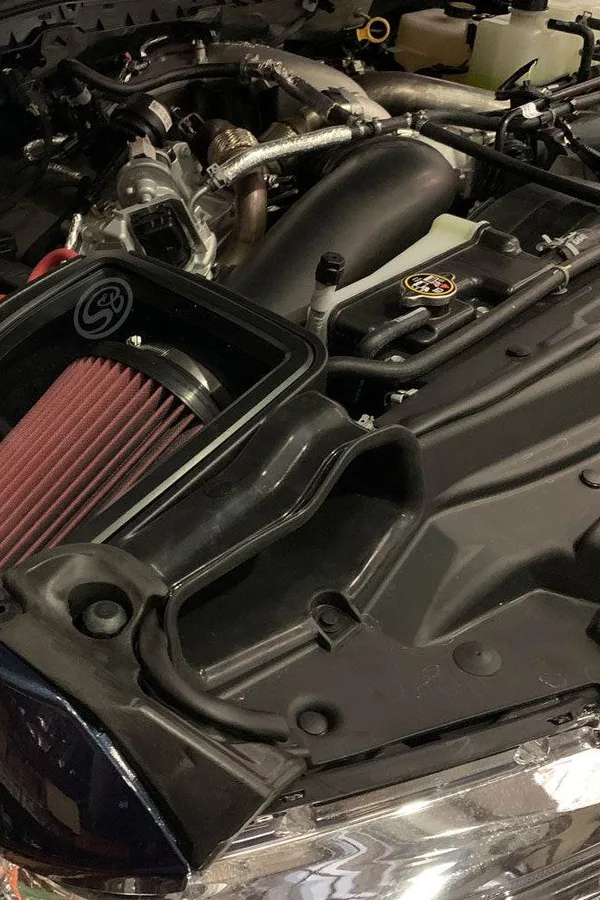 An S&B cold air intake installed in a truck engine bay
