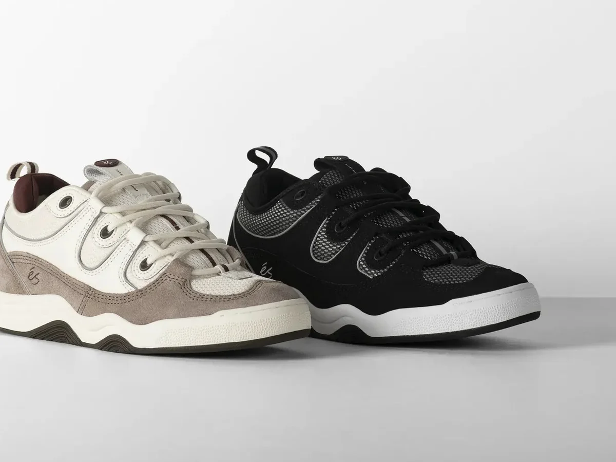 Two pairs of éS Two Nine 8 skate shoes in cream and black on a grey studio floor