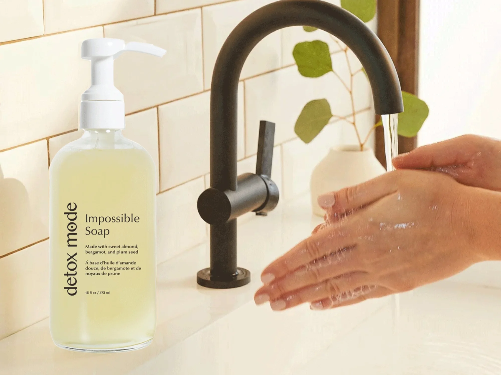 Detox Mode Impossible Soap on a bathroom counter beside a black faucet and a shopper washing their hands