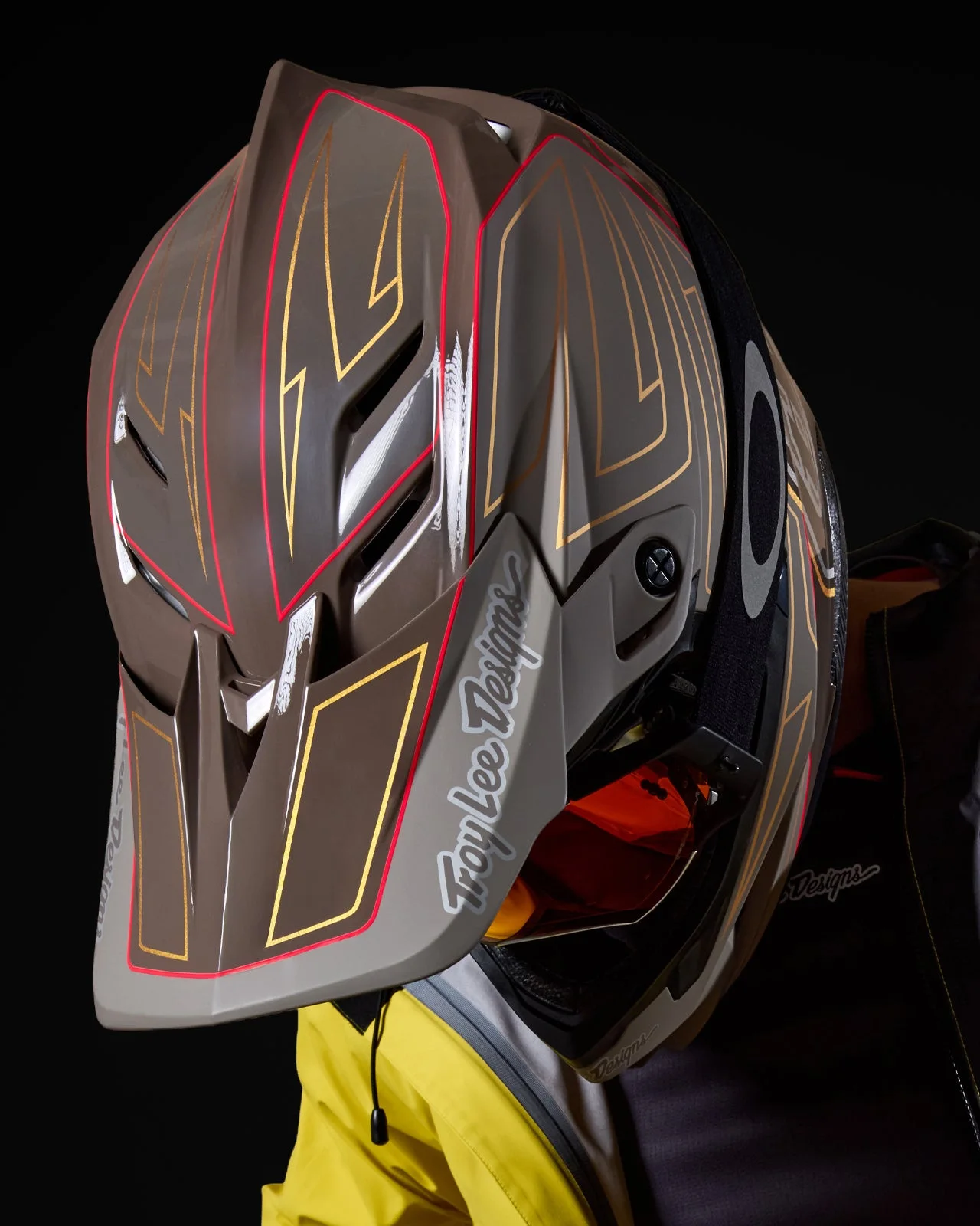 Troy Lee Designs D4 mountain bike helmet with pinstripe graphics on a dark background
